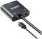 Un adaptateur noir portant les inscriptions « SPEAKA PROFESSIONAL », « 5V/DC » et « Audio », avec un câble connecté et une prise USB.