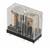 Relais rectangulaire à boîtier transparent en plastique, montrant la bobine de cuivre et les contacts métalliques. Utilisé dans les circuits électriques.