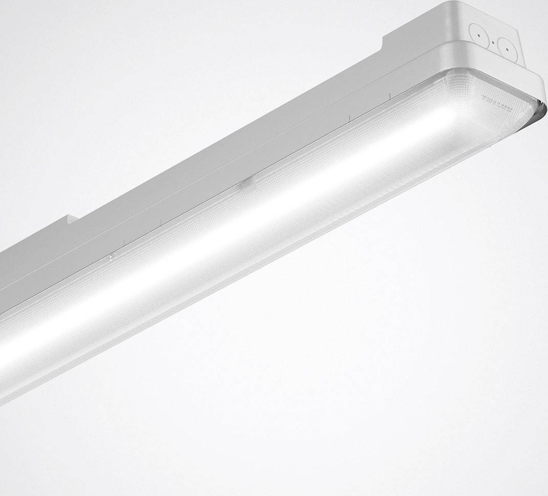 Un luminaire LED blanc qui émet une lumière vive, monté au plafond. Il illustre le style simple et fonctionnel des rampes lumineuses.