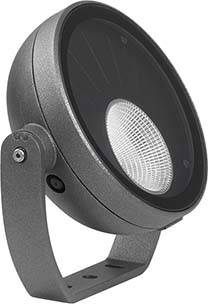 Un projecteur LED gris et rond, avec support réglable, adapté aux utilisations intérieures et extérieures, présente sa lentille frontale.