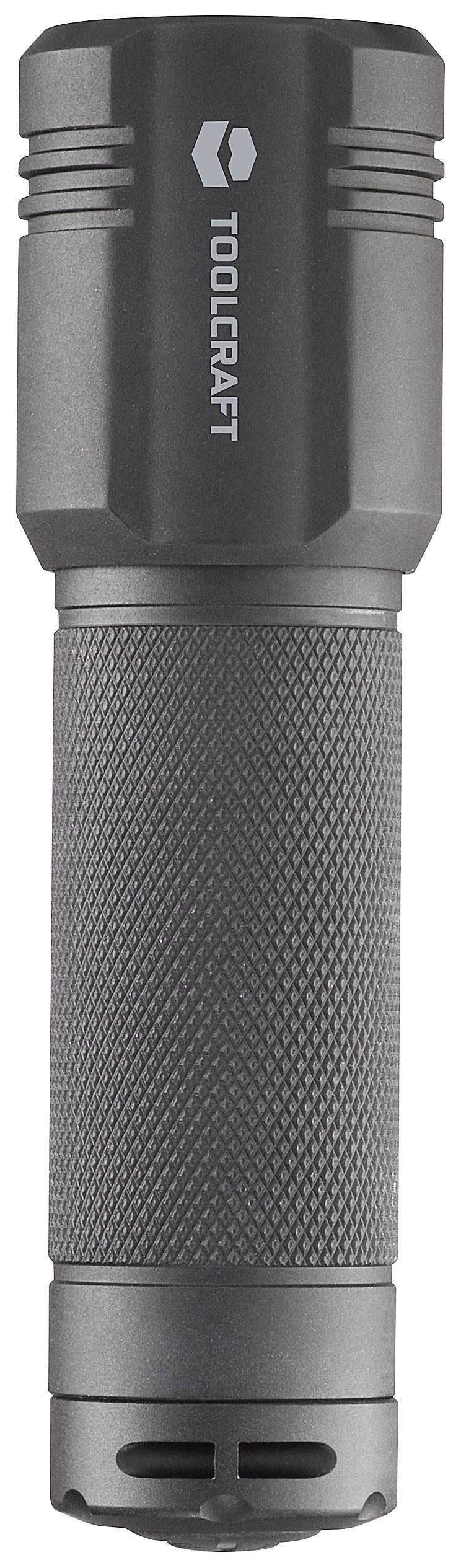 Lampe de poche en métal, cylindrique, noire ; marquée 'TOOLCRAFT' sur la partie supérieure. Adaptée aux activités de plein air.
