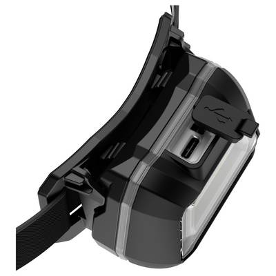 Un appareil noir avec un port USB sur le côté, probablement un chargeur portable ou une lampe frontale.