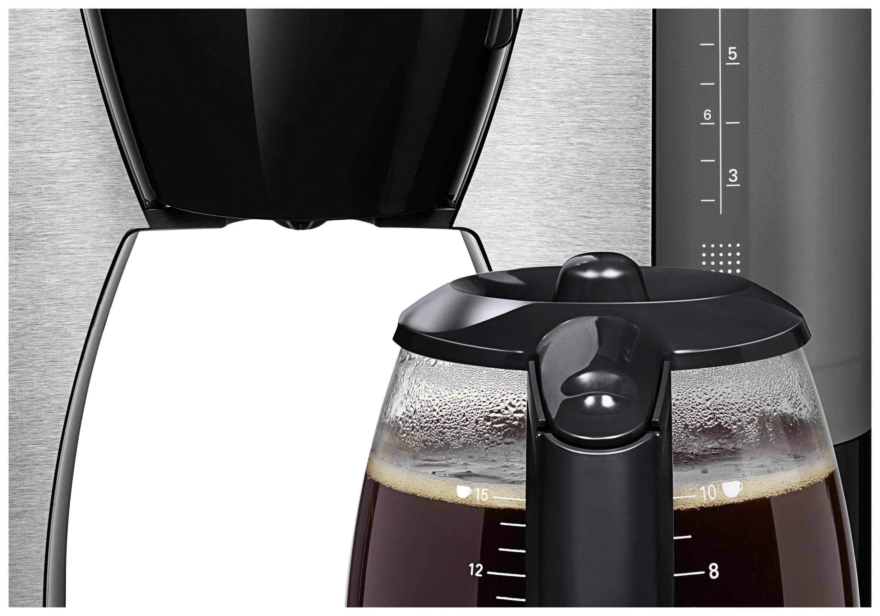 Une machine à café avec une carafe transparente remplie, mesurée en tasses. La machine a un design moderne.