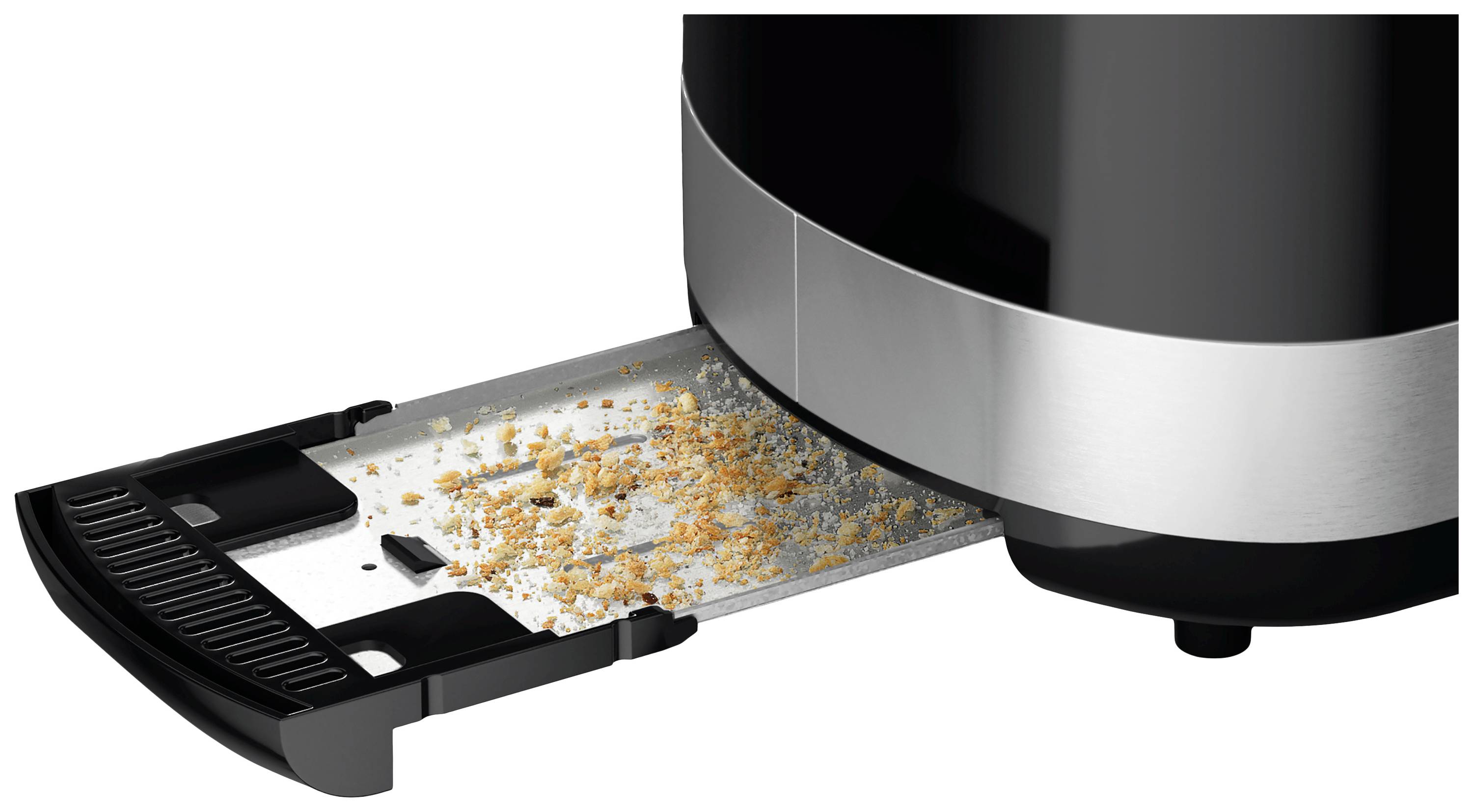 Un grille-pain noir avec un bac à miettes rempli de miettes qui ont été retirées du grille-pain.