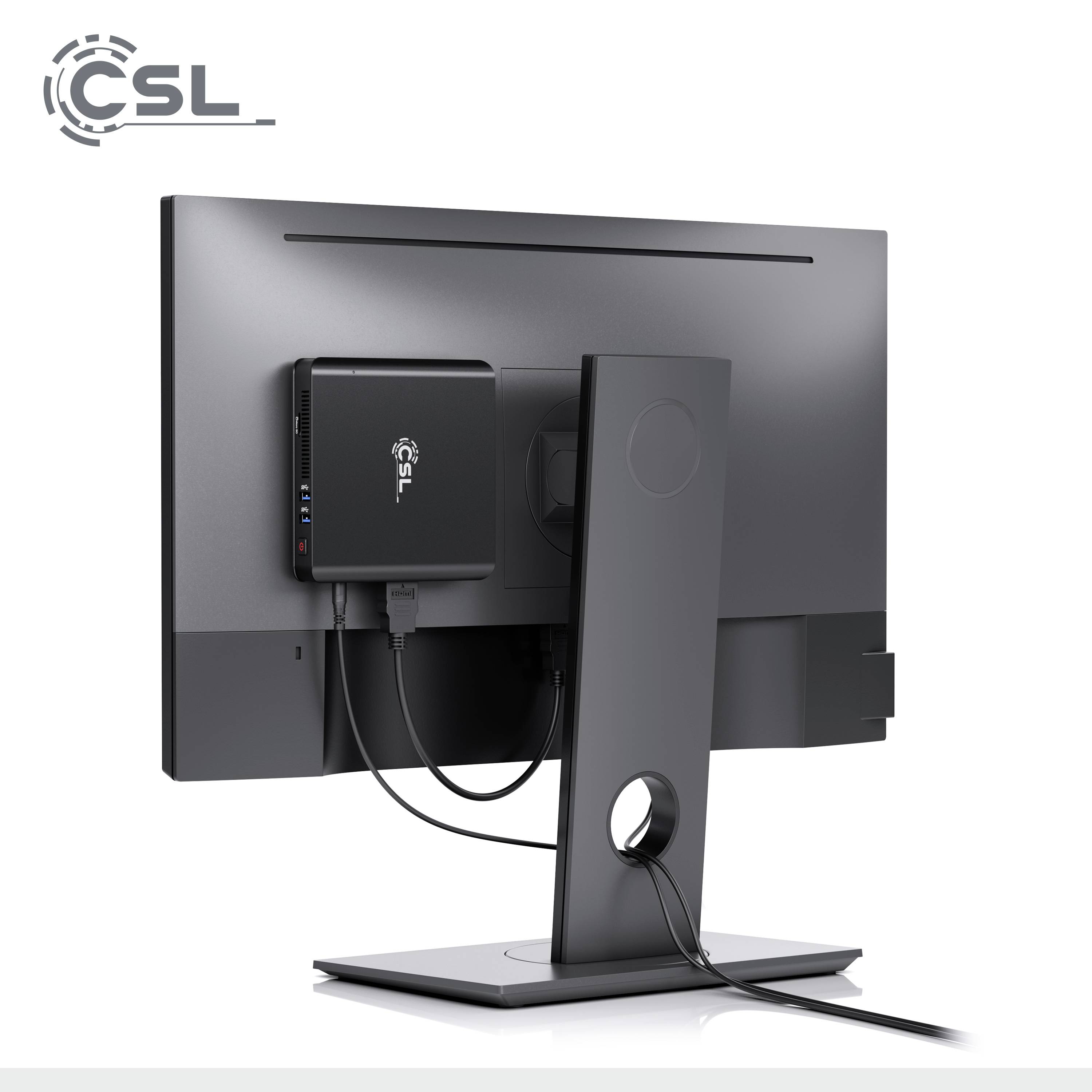 Un ordinateur compact noir est monté à l'arrière d'un moniteur. Les deux appareils sont connectés sans câbles visibles.