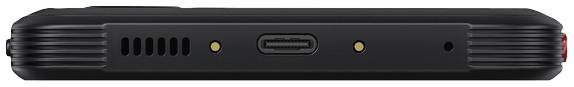 Vue unilatérale d'un appareil électronique noir avec un port USB-C et deux points de contact dorés au centre, entourés de fentes d'aération.
