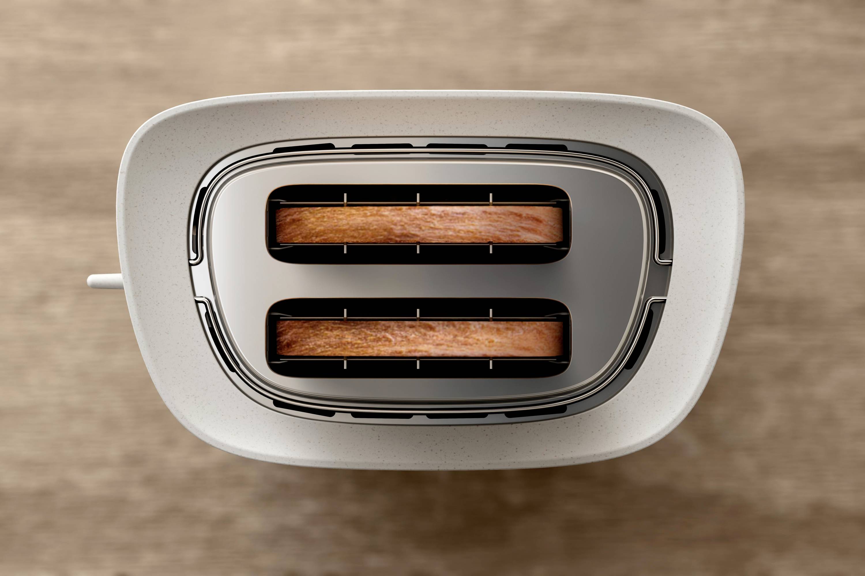 Grille-pain deux tranches, photographié de dessus, avec des tranches brunes dans les fentes. L'arrière-plan est une surface en bois.