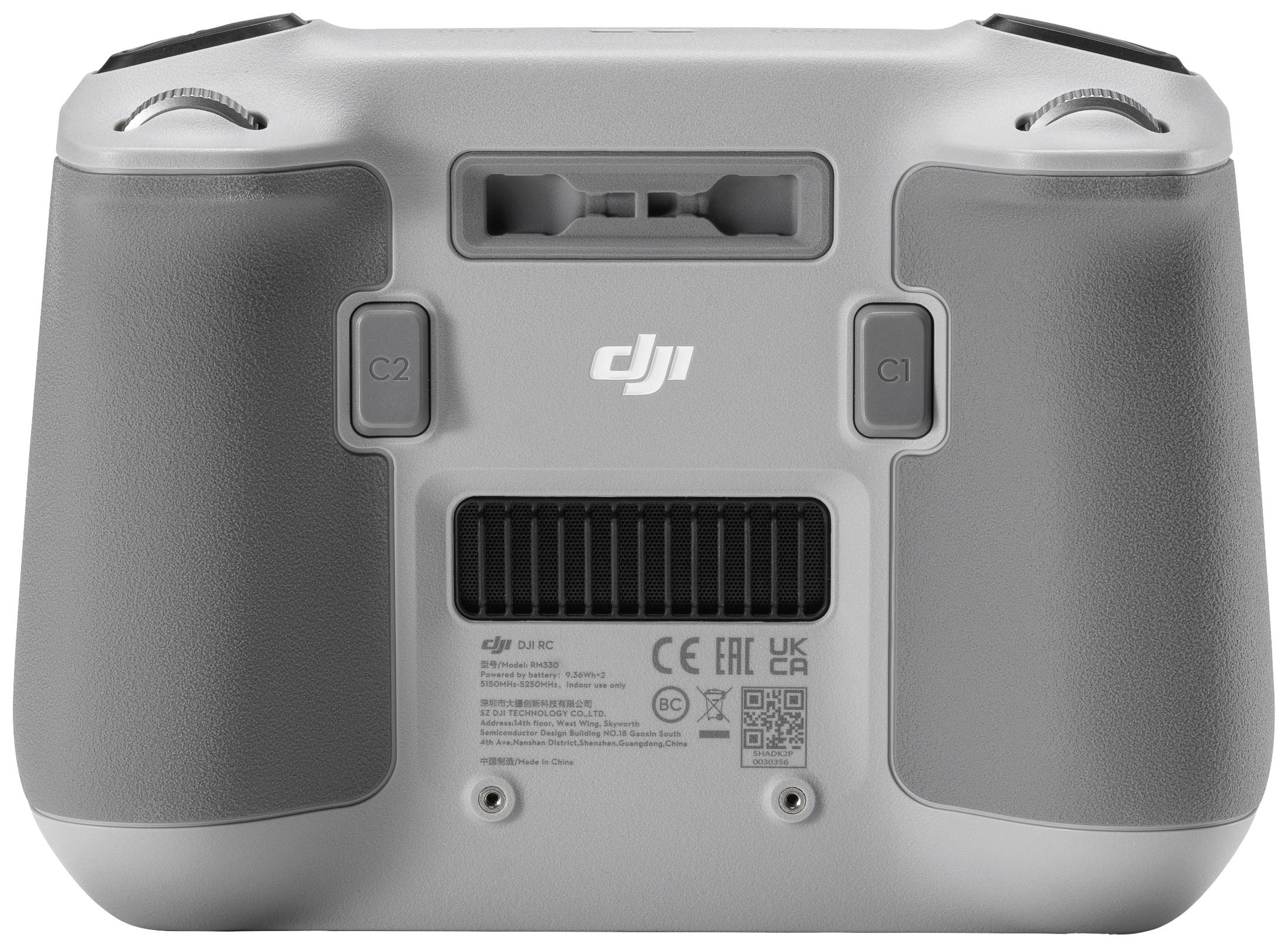 Contrôleur de drone gris avec deux manches de commande et plusieurs boutons, montrant l'arrière avec le logo de la marque et les informations du modèle.