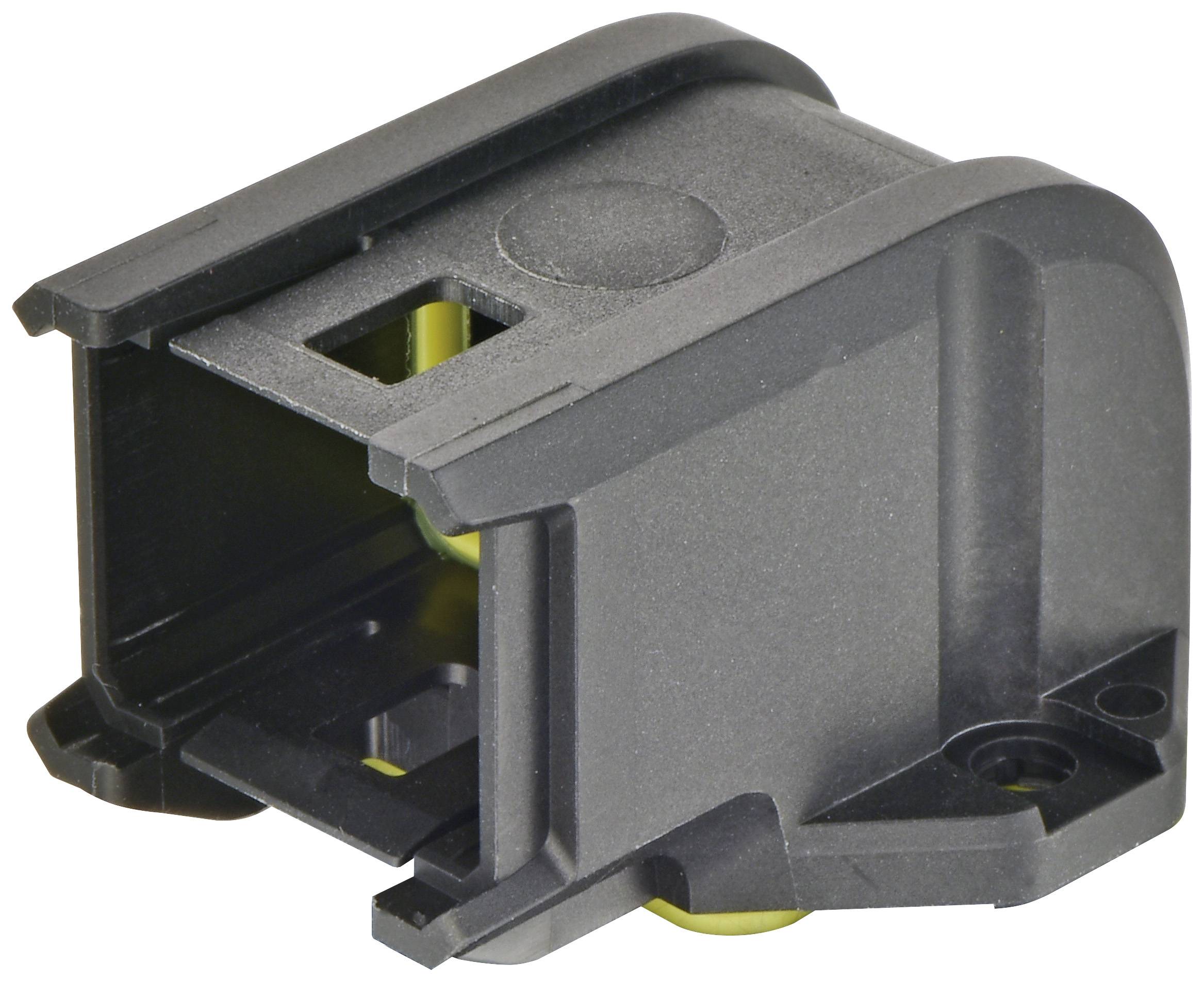 Composant en plastique noir avec une ouverture rectangulaire et des détails jaunes, probablement partie d'un dispositif technique ou d'un boîtier.