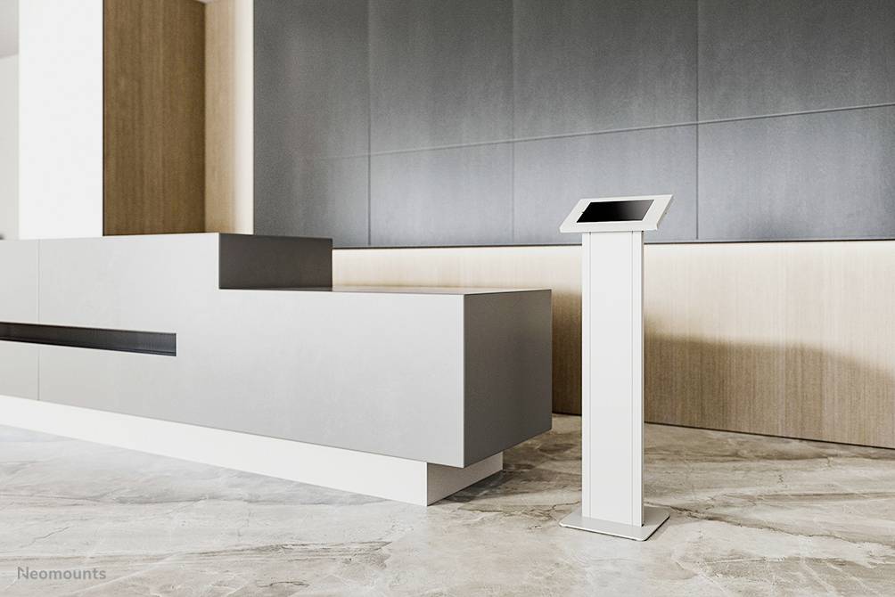 Hall de réception moderne avec un comptoir gris et une borne d'information autonome utilisée pour des accès informatifs interactifs.