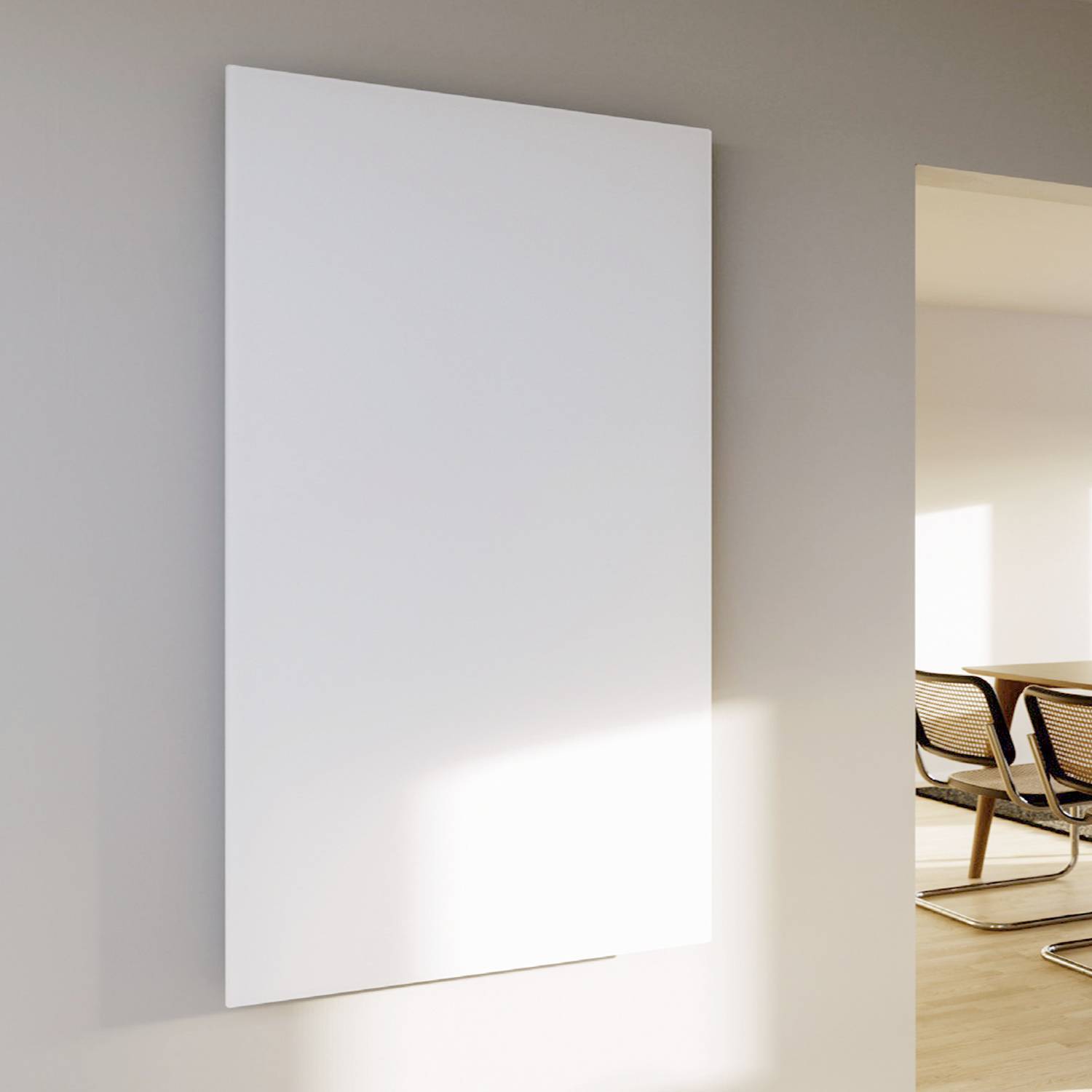 Un cadre photo vide et blanc sur un mur, éclairé par la lumière du soleil. À côté, un espace lumineux avec des chaises est visible.