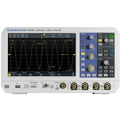 Oscilloscope posé sur une table affichant des ondes sinusoïdales sur l'écran. Panneau de commande à droite avec différents boutons et réglages.