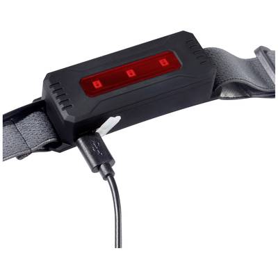 Un chargeur noir connecté à un câble fixé à un ruban textile gris.