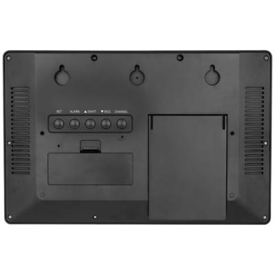 Arrière d'un appareil électronique avec cinq boutons : Réglage, Alarme, +, RCC, Canal. Couvercle des piles en bas à gauche.