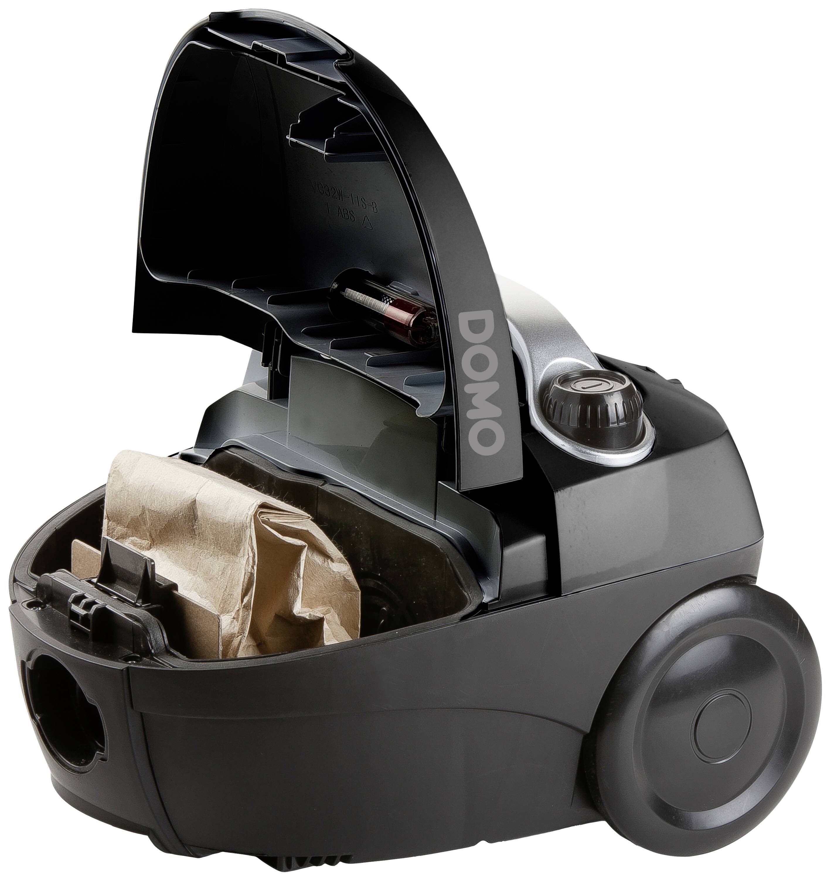 Aspirateur ouvert avec un sac à poussière installé, dont le couvercle porte l'inscription "DOMO". L'appareil montre sa structure interne et ses fonctions.