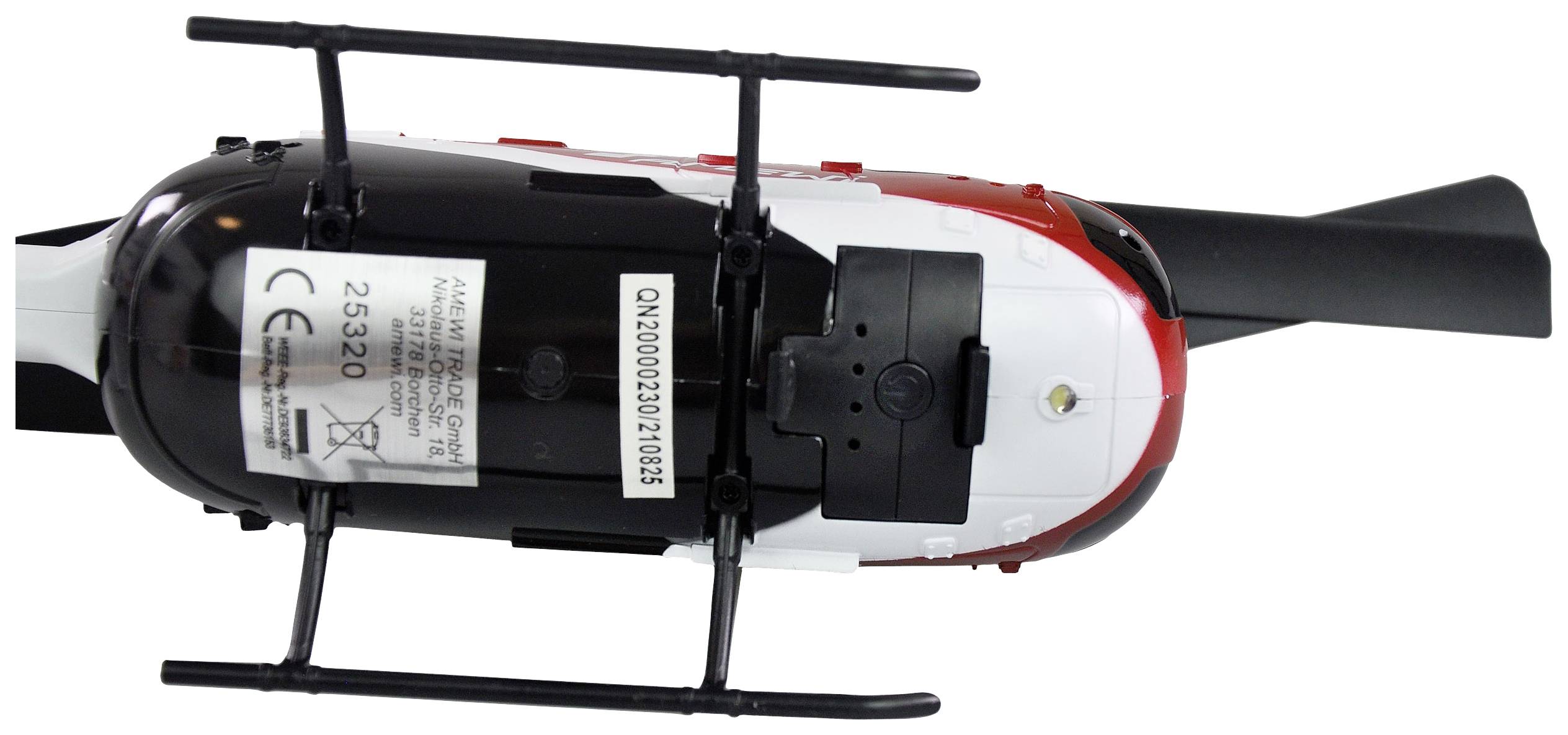 Hélicoptère jouet en noir et blanc avec un détail rouge, photographié de dessus. Le poids central se situe au niveau des supports du rotor principal.