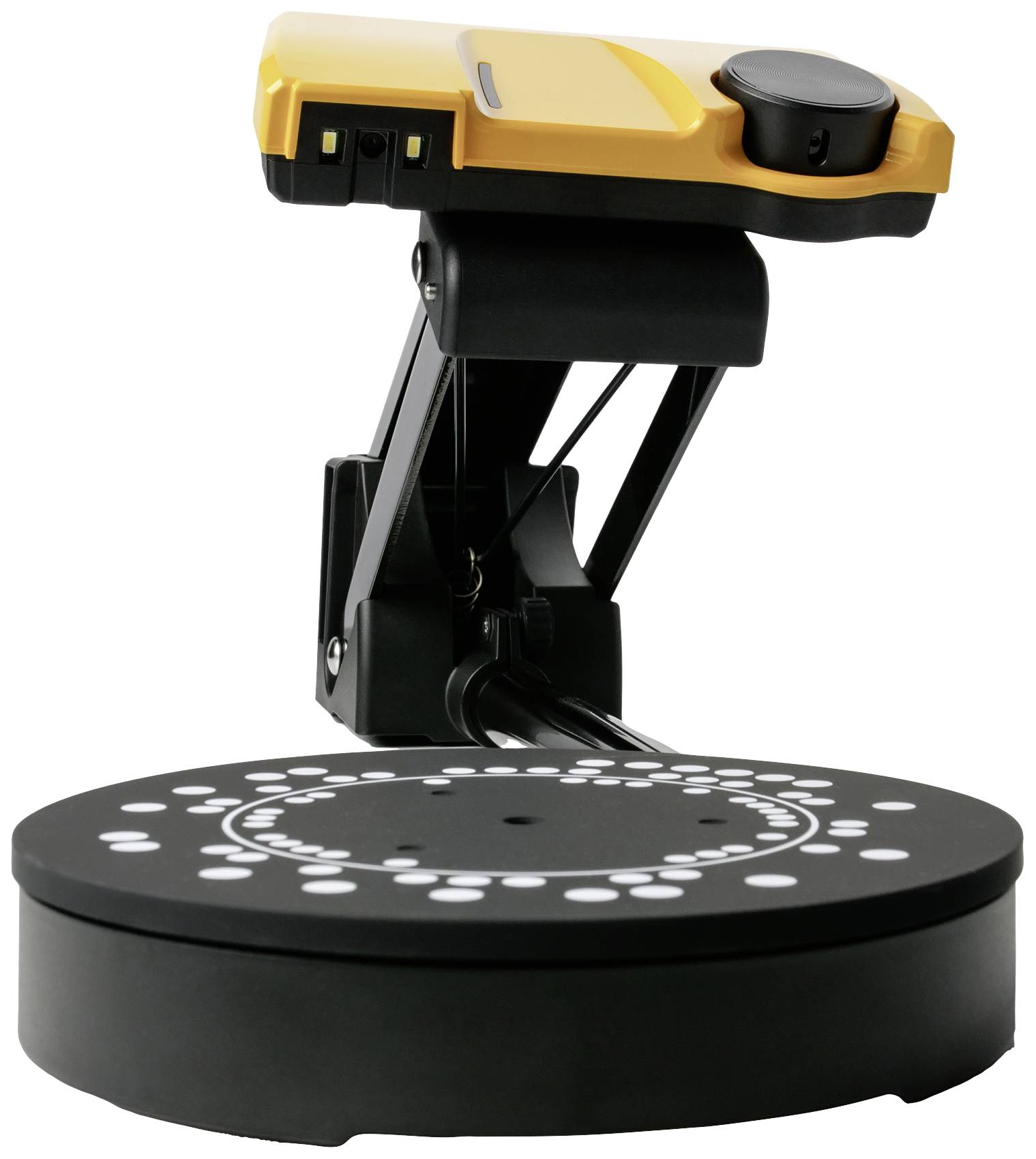 Un scanner 3D avec un boîtier jaune, monté sur un socle noir rotatif. Il contient des points de calibrage marqués en blanc.