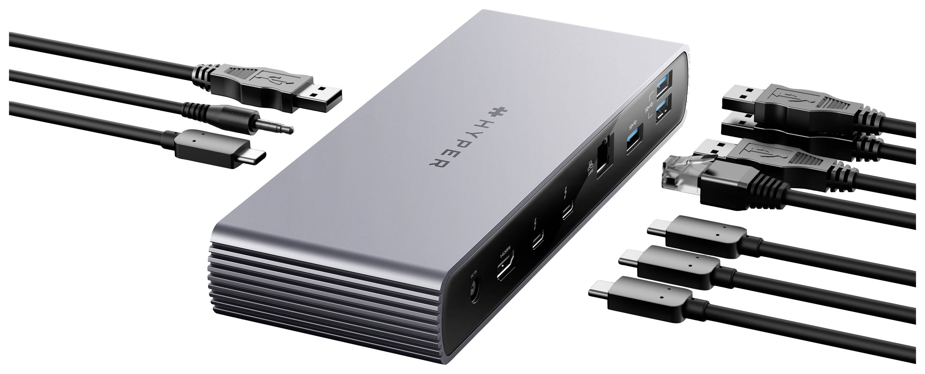 Une station d'accueil argentée avec plusieurs ports, entourée de divers câbles permettant de connecter différents appareils.