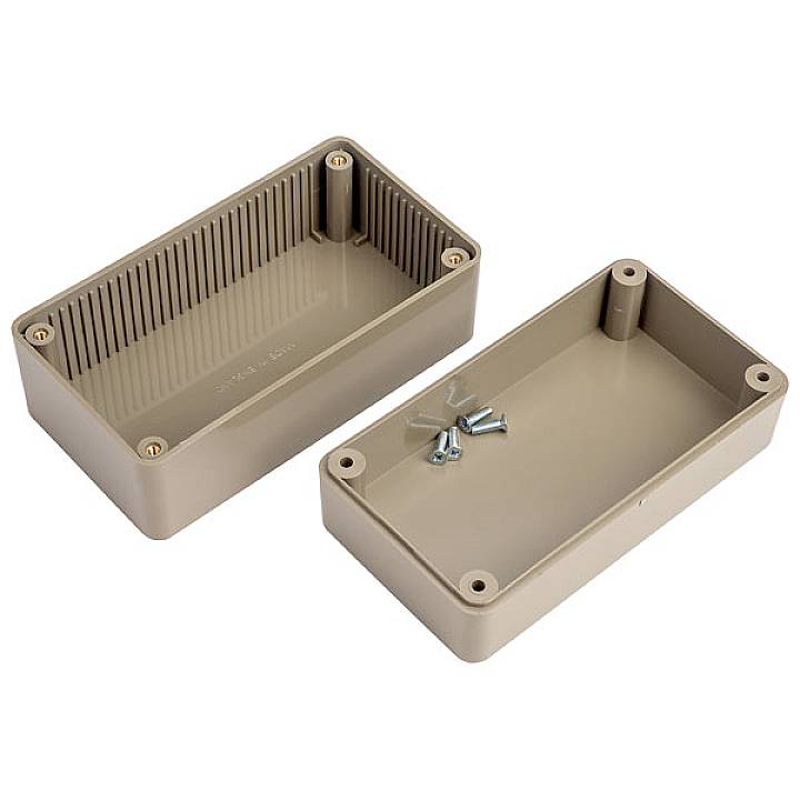 Boîtier en plastique marron en deux parties avec des vis. Les parties ouvertes en haut et en bas montrent des points de fixation et des rainures.