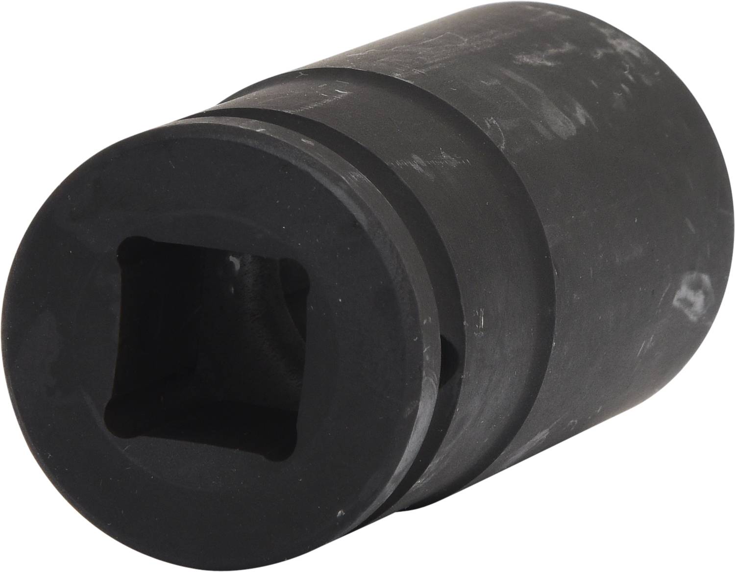 Noix de serrage noire, cylindrique, avec ouverture carrée, légèrement usée. Adaptée aux outils et applications mécaniques.