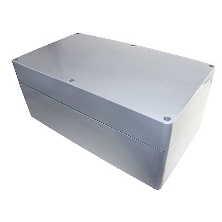 Boîtier rectangulaire en plastique gris, probablement destiné à des applications électriques ou industrielles, sans logos ni inscriptions.