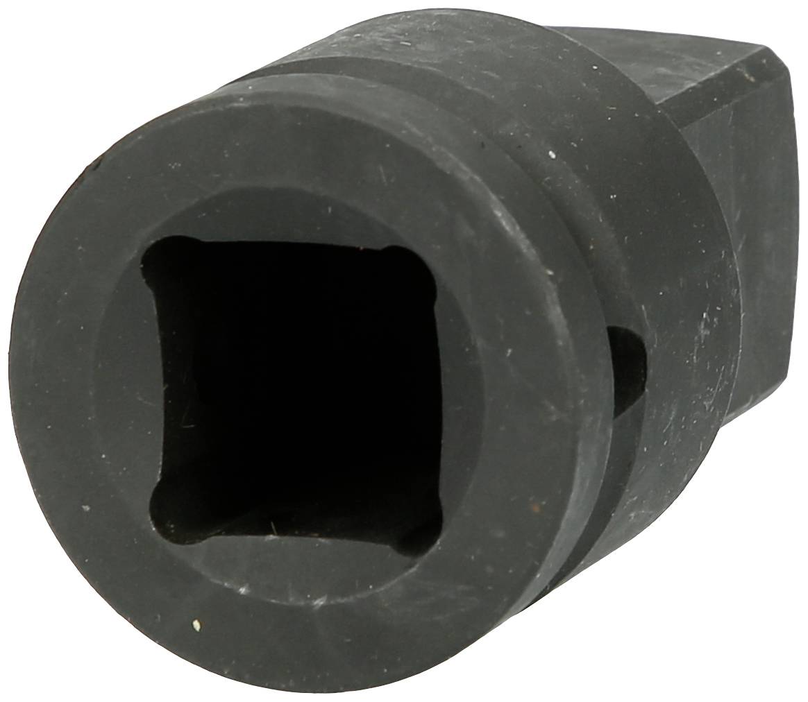 Un objet noir, cylindrique, avec un espace intérieur carré, ressemblant à un adaptateur ou à un connecteur.