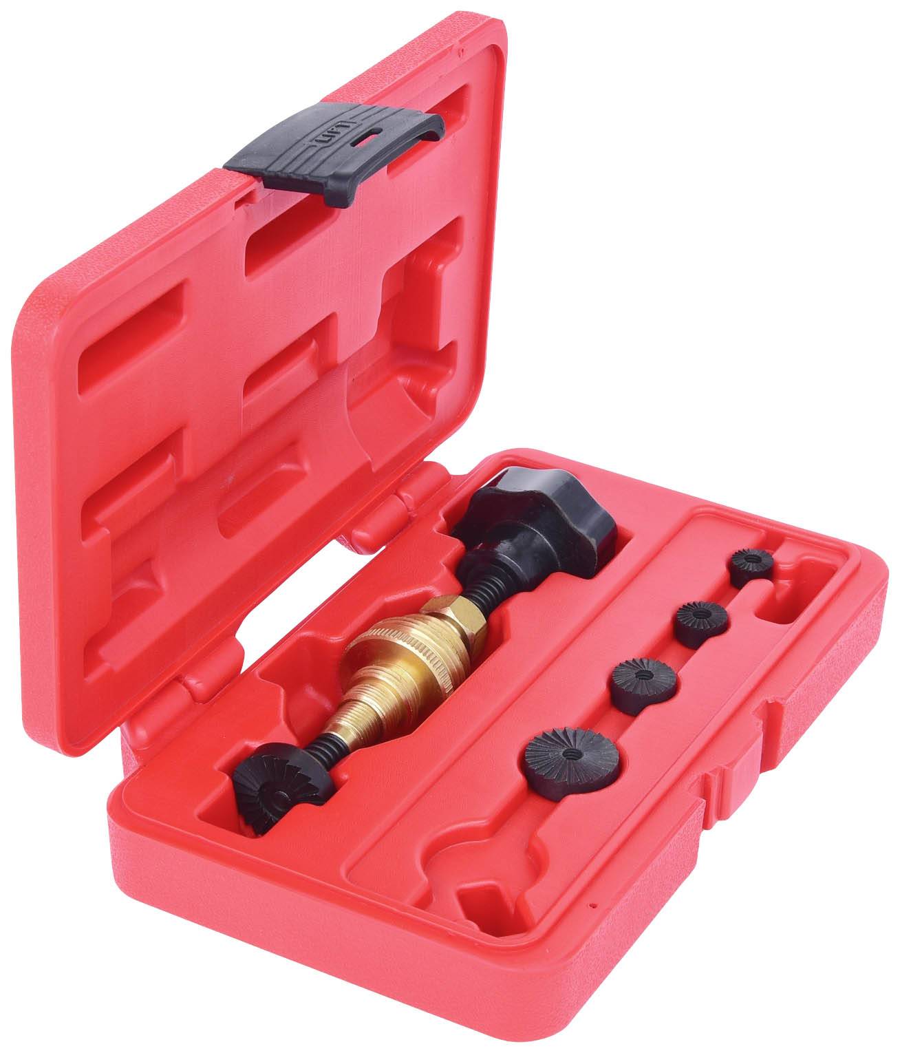 Valise en plastique rouge avec couvercle ouvert, contenant un outil en laiton et plusieurs embouts noirs.