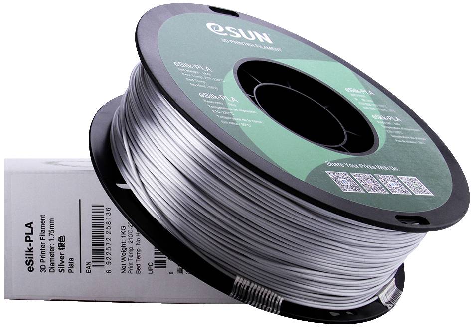 Une bobine de filament eSun eSilk-PLA argenté pour imprimante 3D, posée sur un carton blanc.