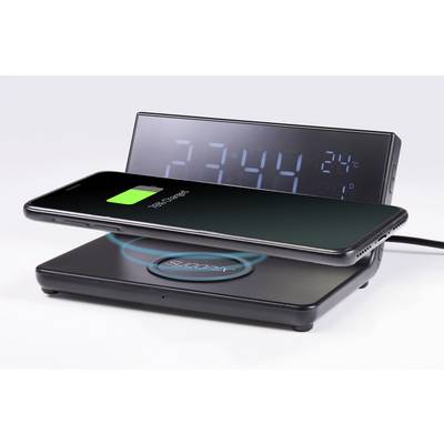 Un smartphone se charge sans fil sur un chargeur. En arrière-plan, un affichage numérique indique l'heure '23:44' et la température '24°C'.