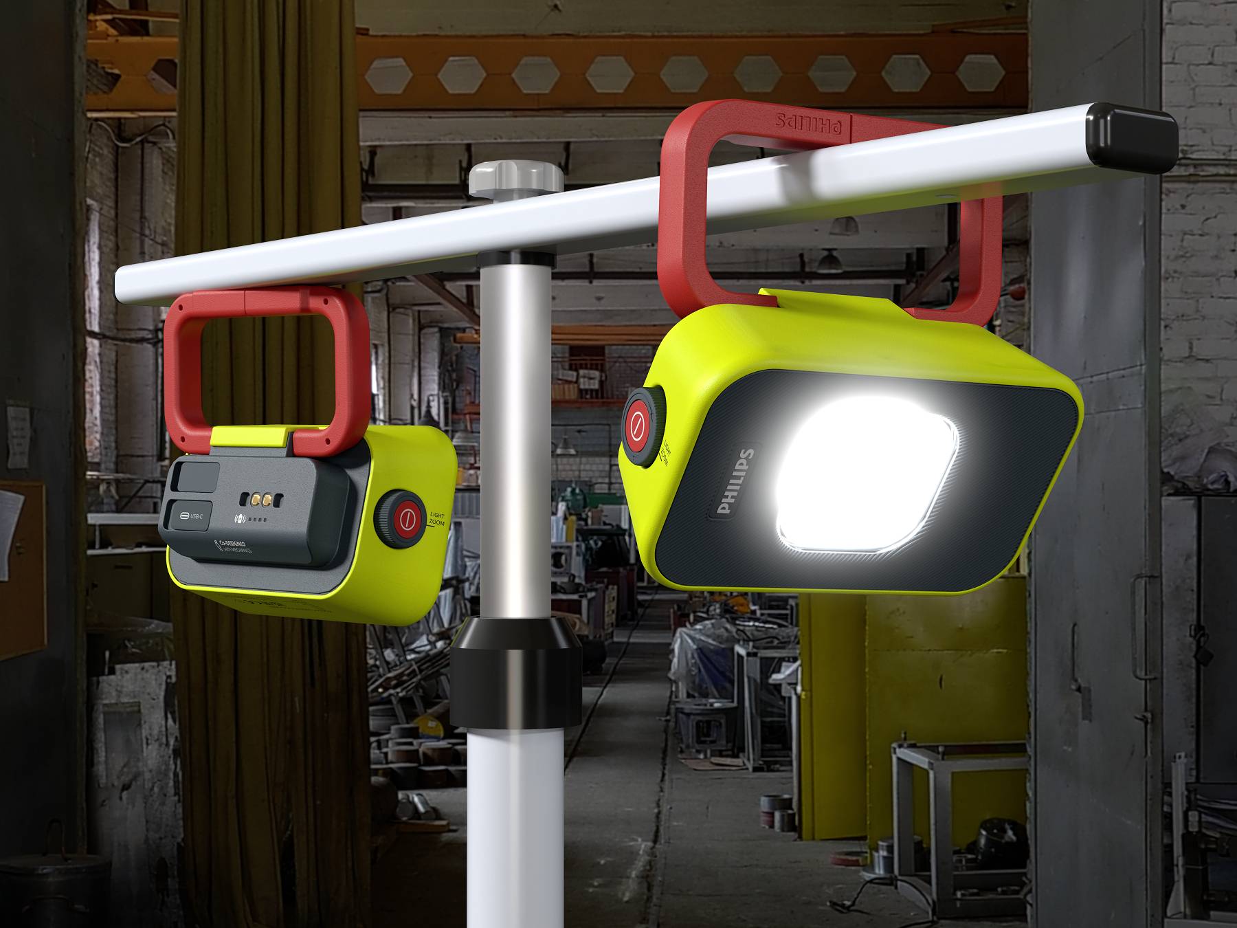 Deux lampes de travail LED portables sur un support métallique dans un atelier. L'une des lampes est allumée et brille intensément.