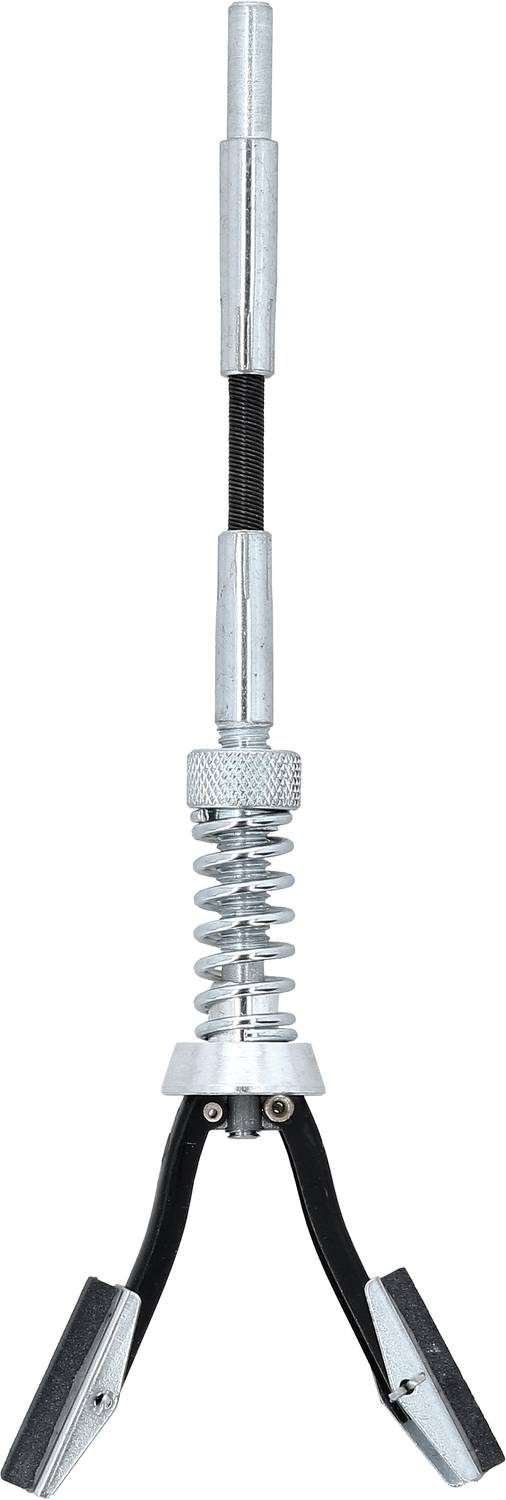 Un outil de préhension magnétique avec pince et mécanisme à ressort, adapté pour saisir de petits objets métalliques dans des zones difficiles d'accès.
