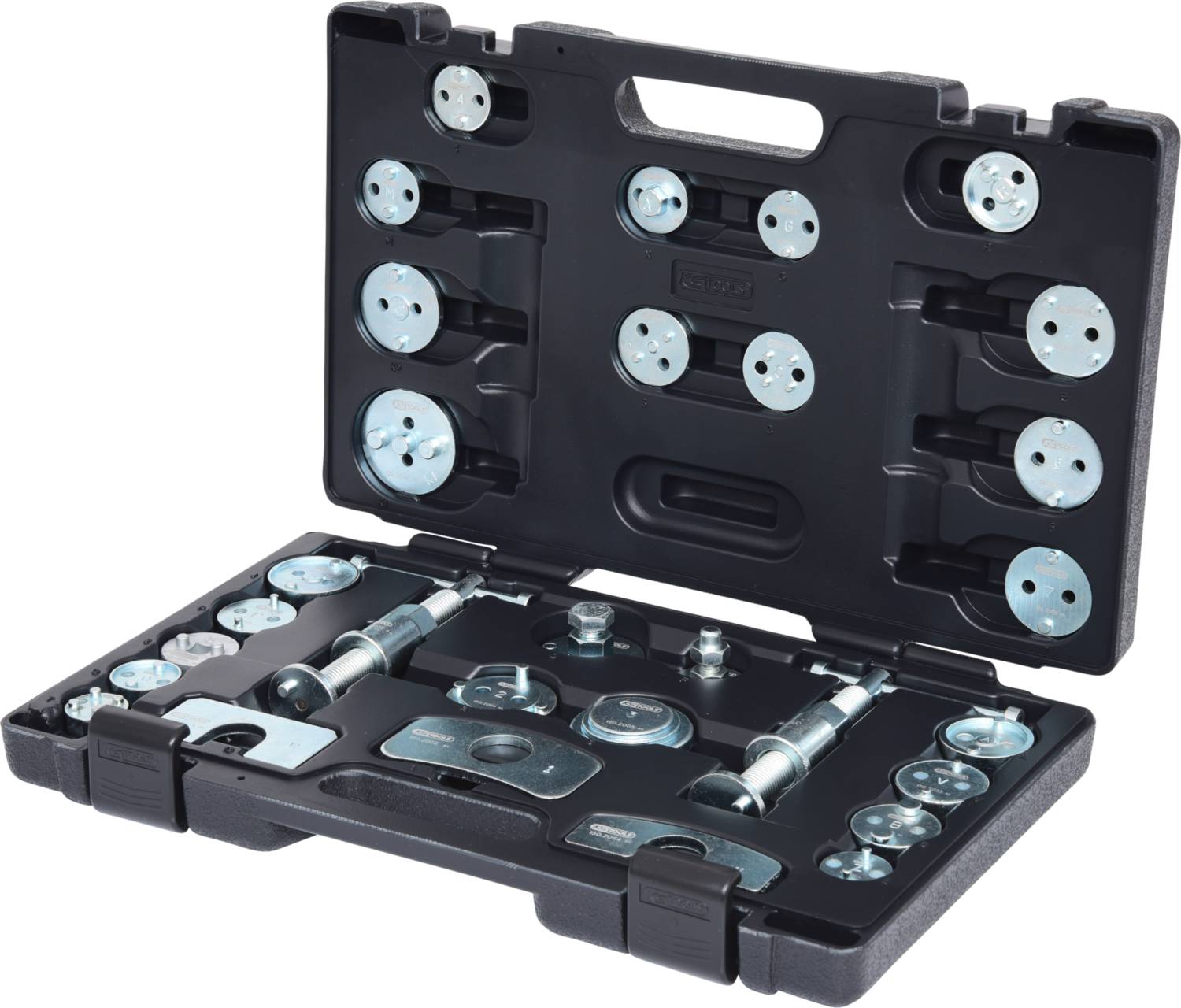 Coffret ouvert en plastique noir contenant un ensemble d'outils métalliques, composé de diverses pièces rondes et cylindriques pour réparations automobiles.