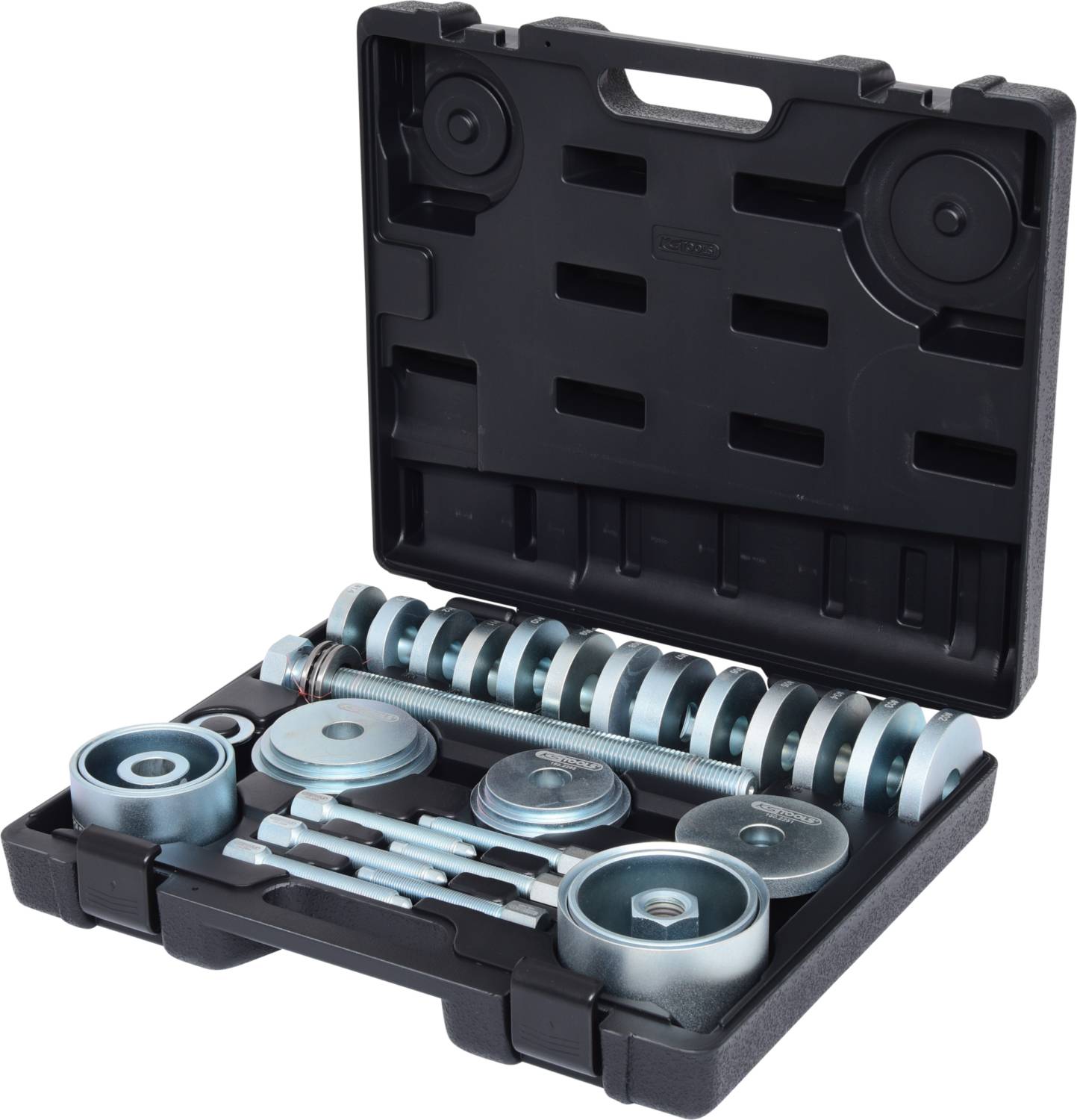 Une valise noire ouverte contenant divers outils et disques métalliques utilisés pour les réparations automobiles ou mécaniques.