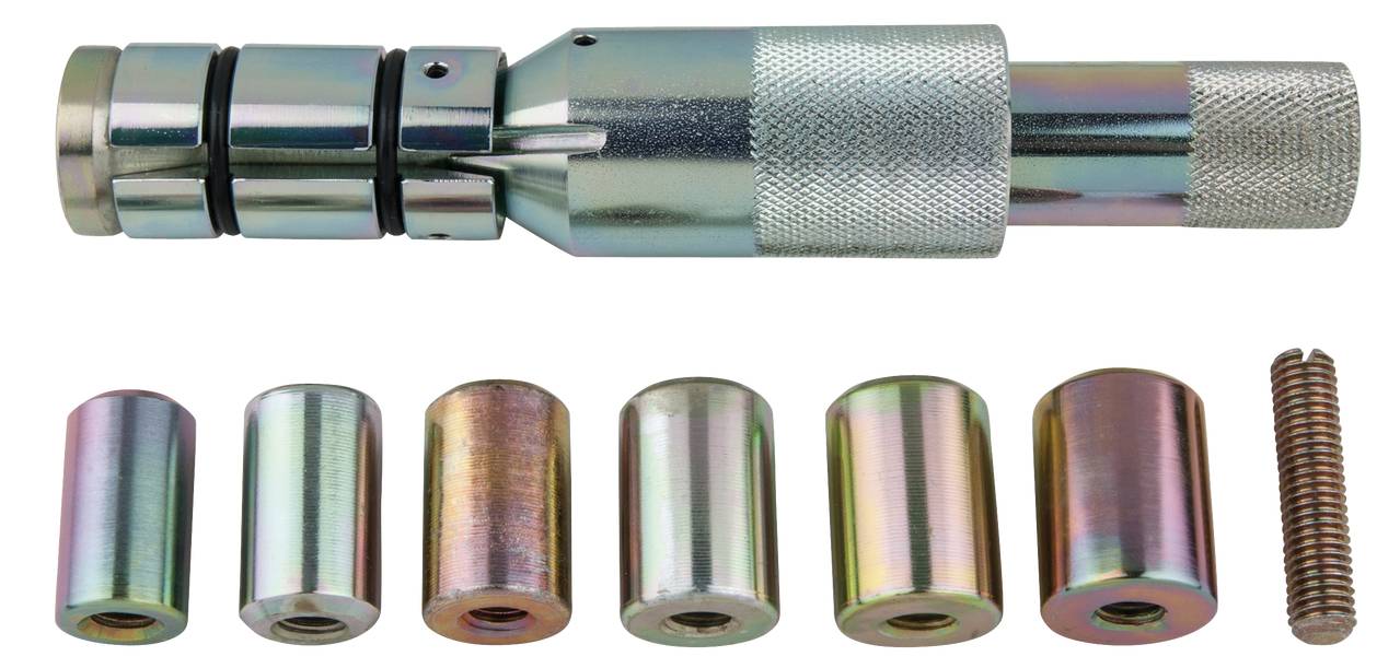 Ensemble d'outils pour chevilles coniques avec cheville conique. En haut se trouve la poignée conique, en bas sont disposées différentes tailles de chevilles coniques et un ressort.