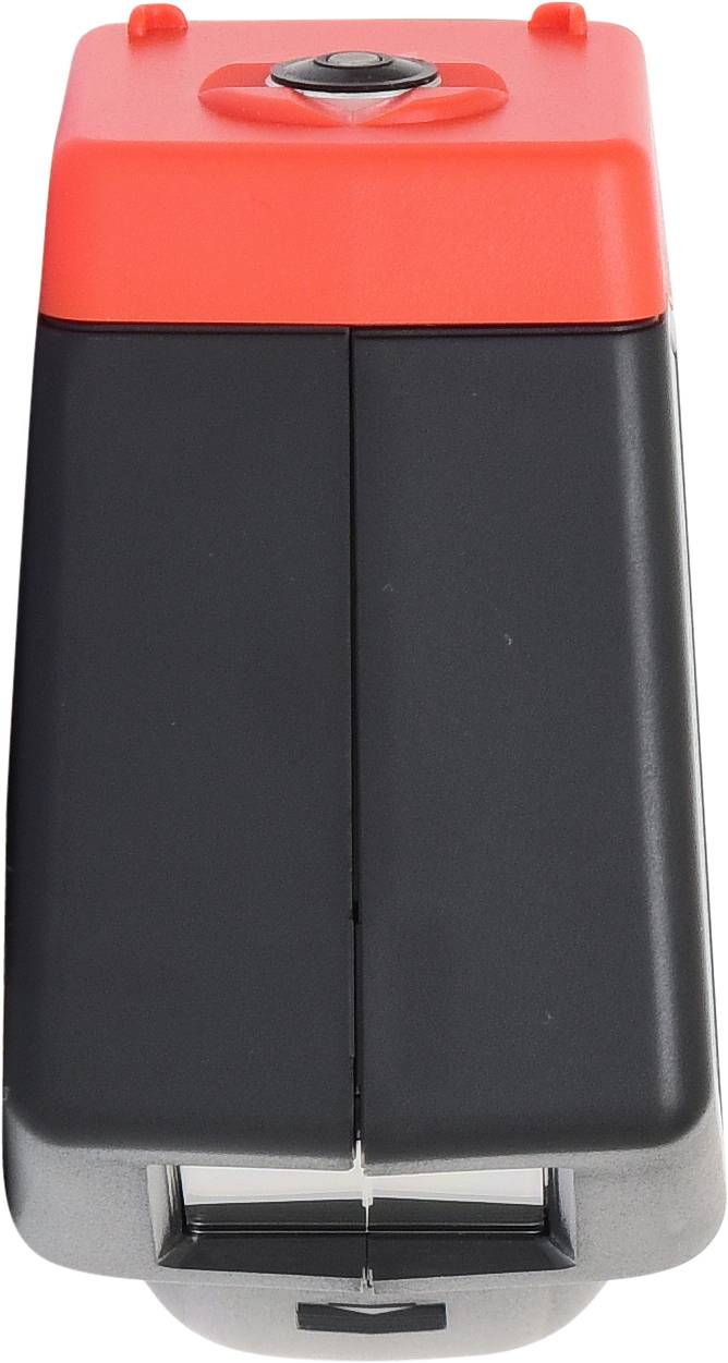 Appareil électrique noir et rouge de forme rectangulaire avec un bouton rond en haut. Le but et la fonction ne sont pas évidents.