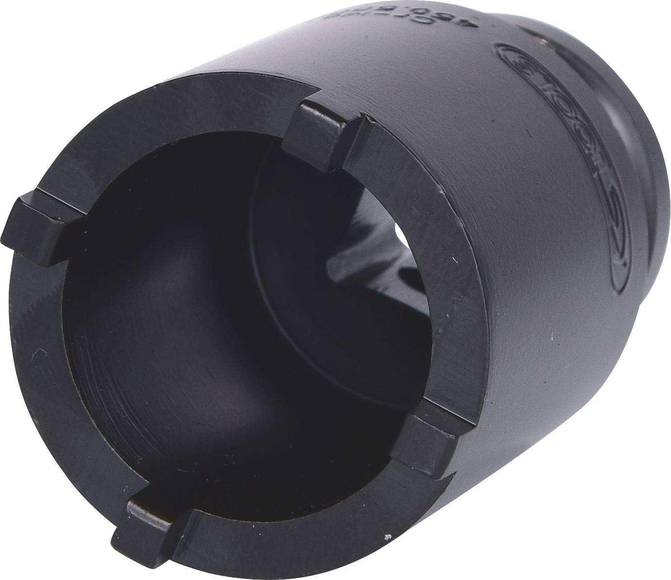 Un fourreau noir cylindrique avec quatre encoches à une extrémité. Il est probablement utilisé comme outil ou accessoire dans des applications techniques.