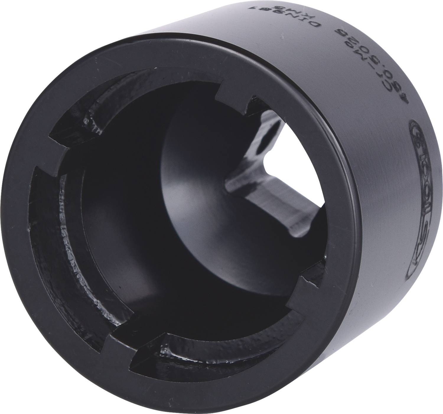 Objet cylindrique noir en métal avec des fentes, probablement un accessoire spécialisé pour un outil à main spécifique.