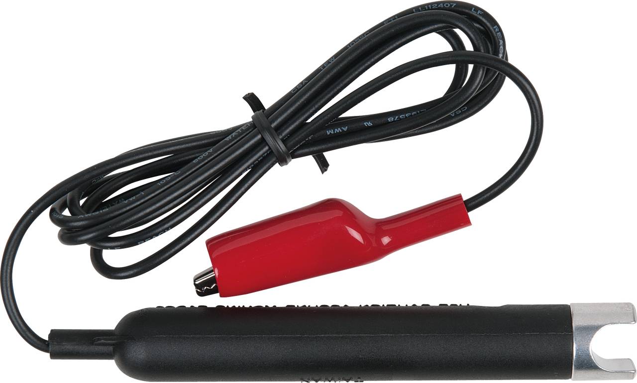 Un testeur de bougie d'allumage noir avec une pince crocodile rouge et un câble, utilisé pour vérifier le fonctionnement des bougies d'allumage.