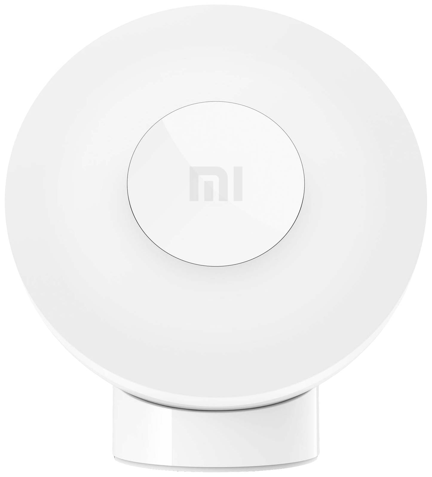 Lampe LED blanche, ronde, avec le logo 'mi' au centre. Elle présente une forme simple et moderne.
