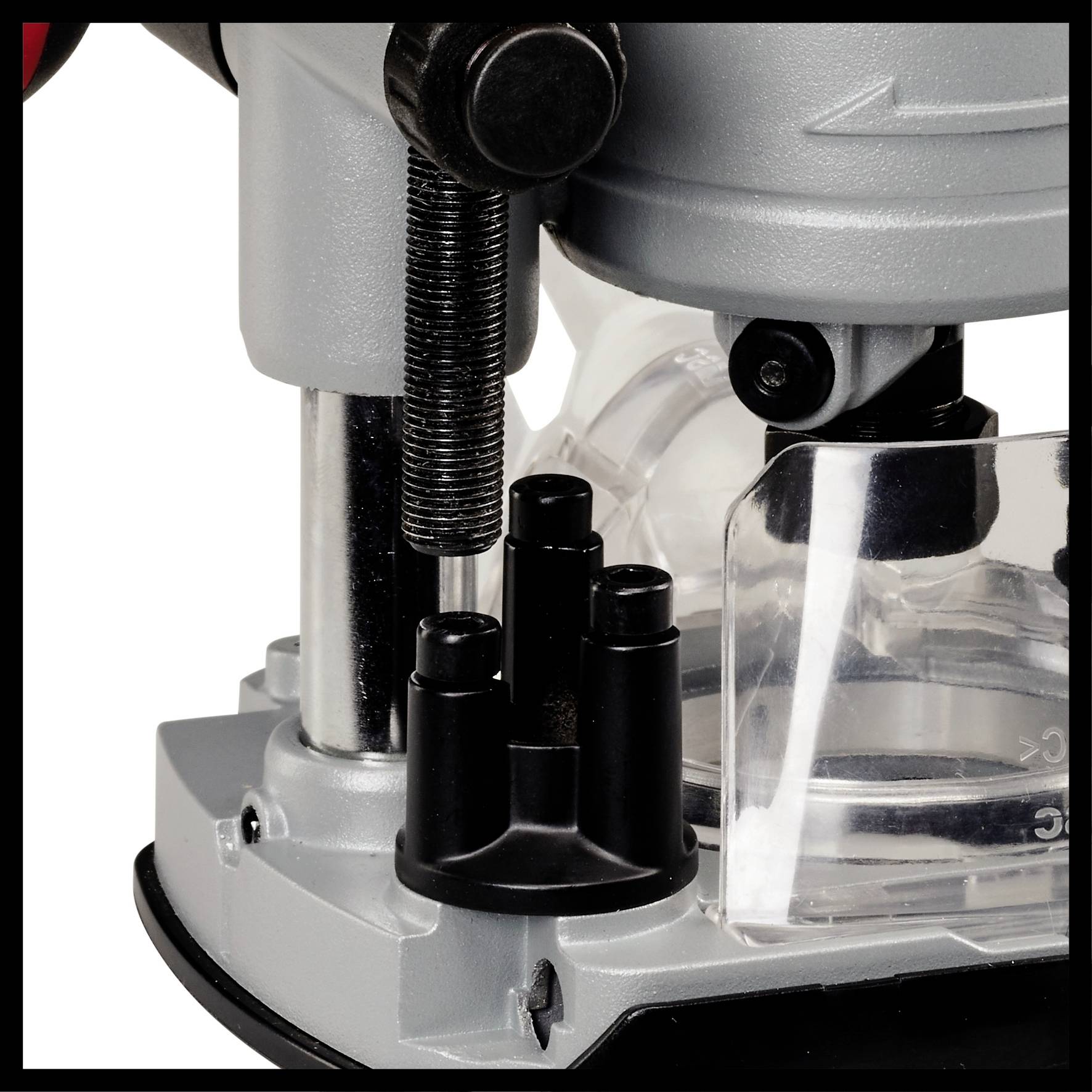 Un détail d'un dispositif mécanique, probablement une machine ou un outil, avec des composants en métal et en plastique.