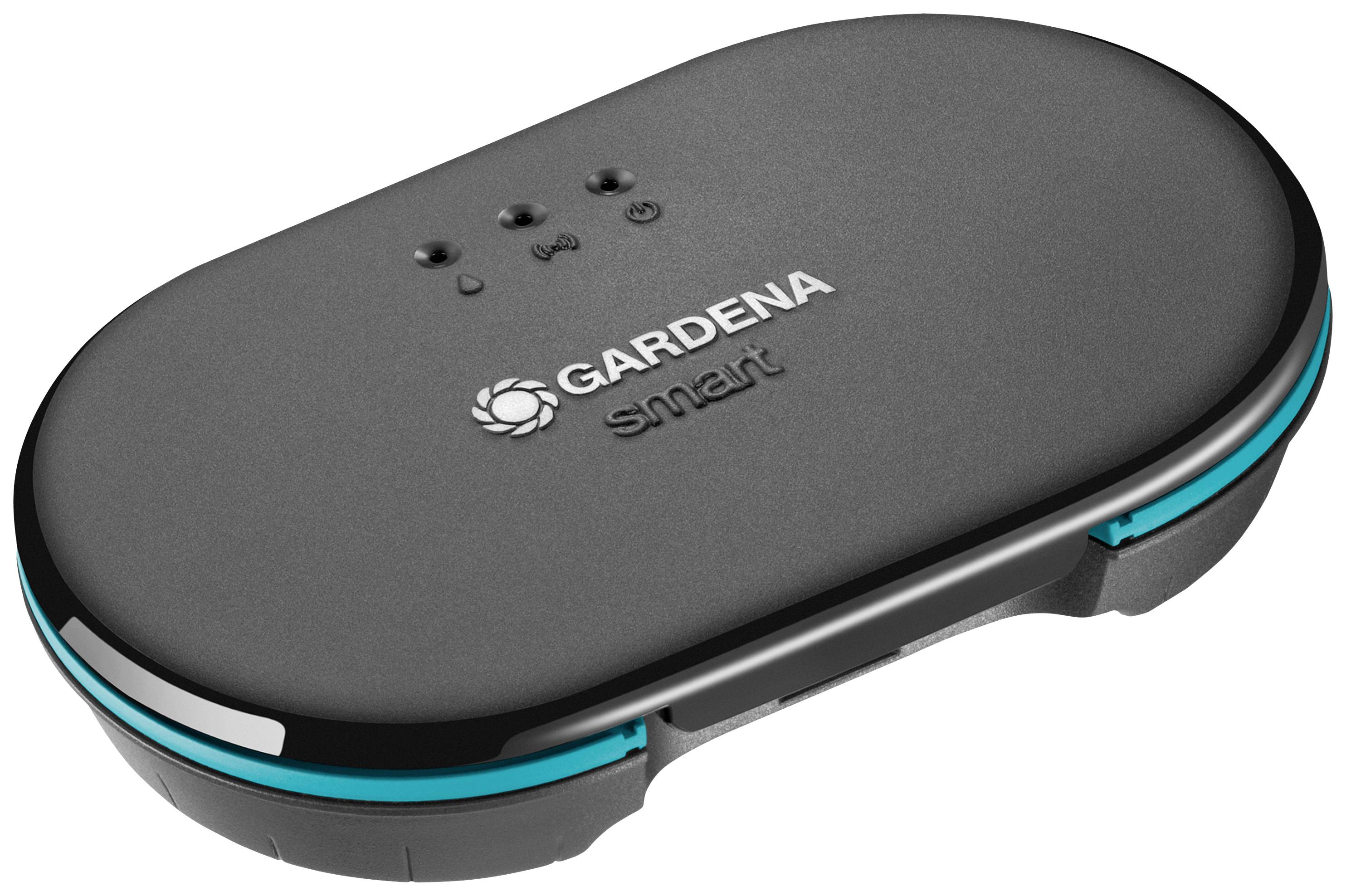 Appareil noir et ovale avec des touches bleues, de la marque 'Gardena Smart', affichant des voyants LED sur sa surface supérieure.