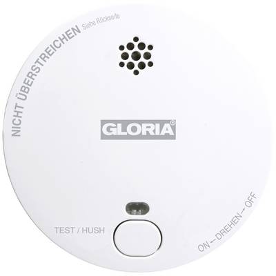 Détecteur de fumée rond portant l'inscription 'GLORIA', avec un bouton de test, une petite grille pour le son d'alarme et des instructions d'utilisation.