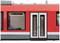 Un train régional rouge portant l'inscription 'RE25 Giessen' à côté d'une porte. À gauche, une fenêtre avec le numéro de siège '2'.