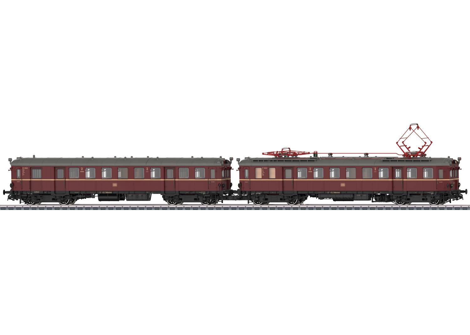 Deux trains de modélisme ferroviaire marron sont sur une voie. À gauche, un wagon standard, à droite, un wagon avec un pantographe rouge.