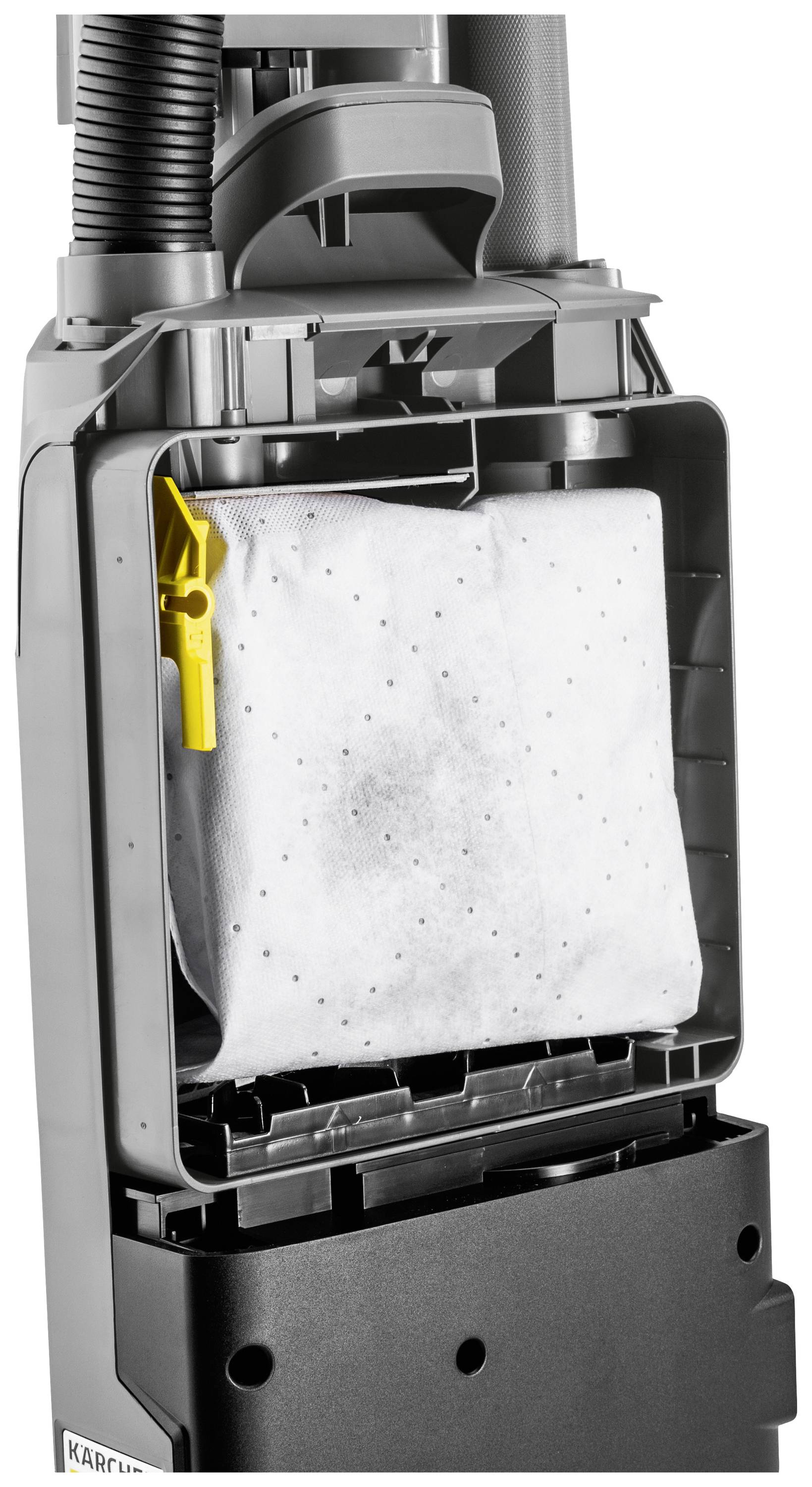 Un aspirateur avec un compartiment ouvert montrant le sac à poussière et son support. Le clip jaune sur le côté gauche est clairement visible.