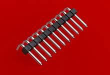 'Barrette électronique sur fond rouge. Les broches sont disposées en deux rangées et légèrement incurvées vers l'intérieur.'