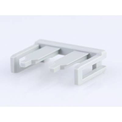 Pièce en plastique grise à trois pointes sur fond blanc. Composant possible d'un appareil ou d'une machine plus grand.