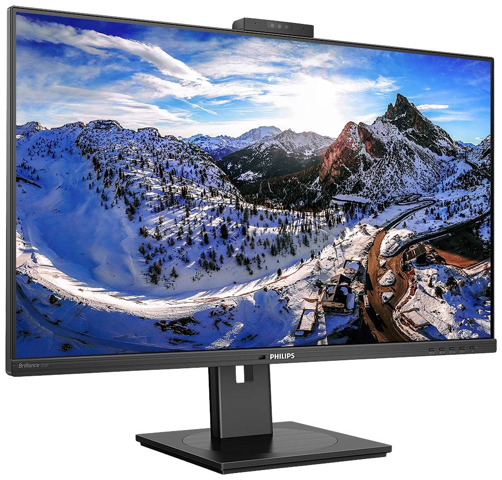 Un moniteur Philips affiche un panorama montagneux hivernal avec des sommets enneigés et une route. Un ciel dégagé est visible en arrière-plan.