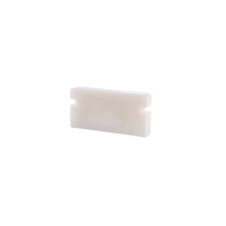 Un bloc rectangulaire en plastique blanc sur un fond neutre.