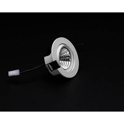 Luminaire encastrable rond argenté avec câble électrique sur un fond noir.